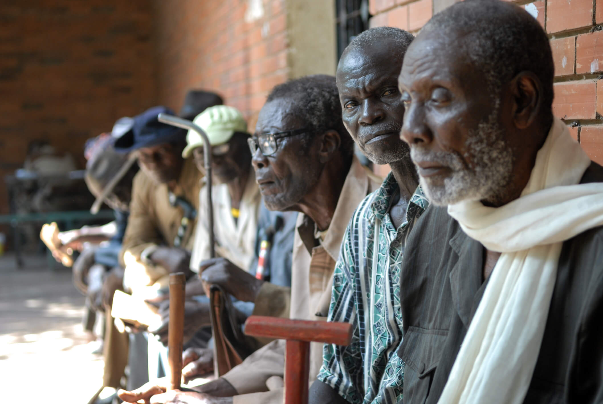 men-sitting-outside-building-chad